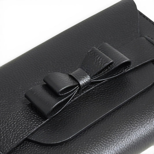 Black leather clutch bag with a bow