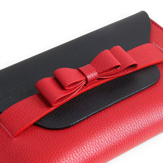 Black and red leather clutch bag with a bow