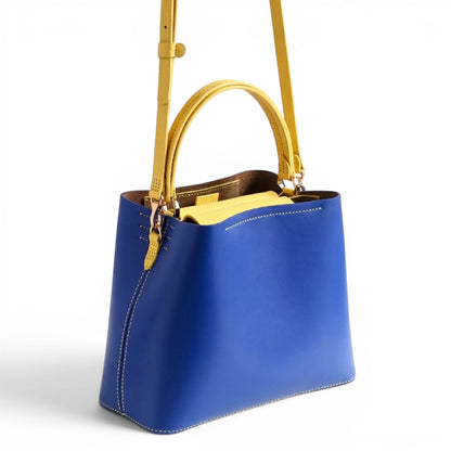 Blue and yellow leather handbag with handle and strap