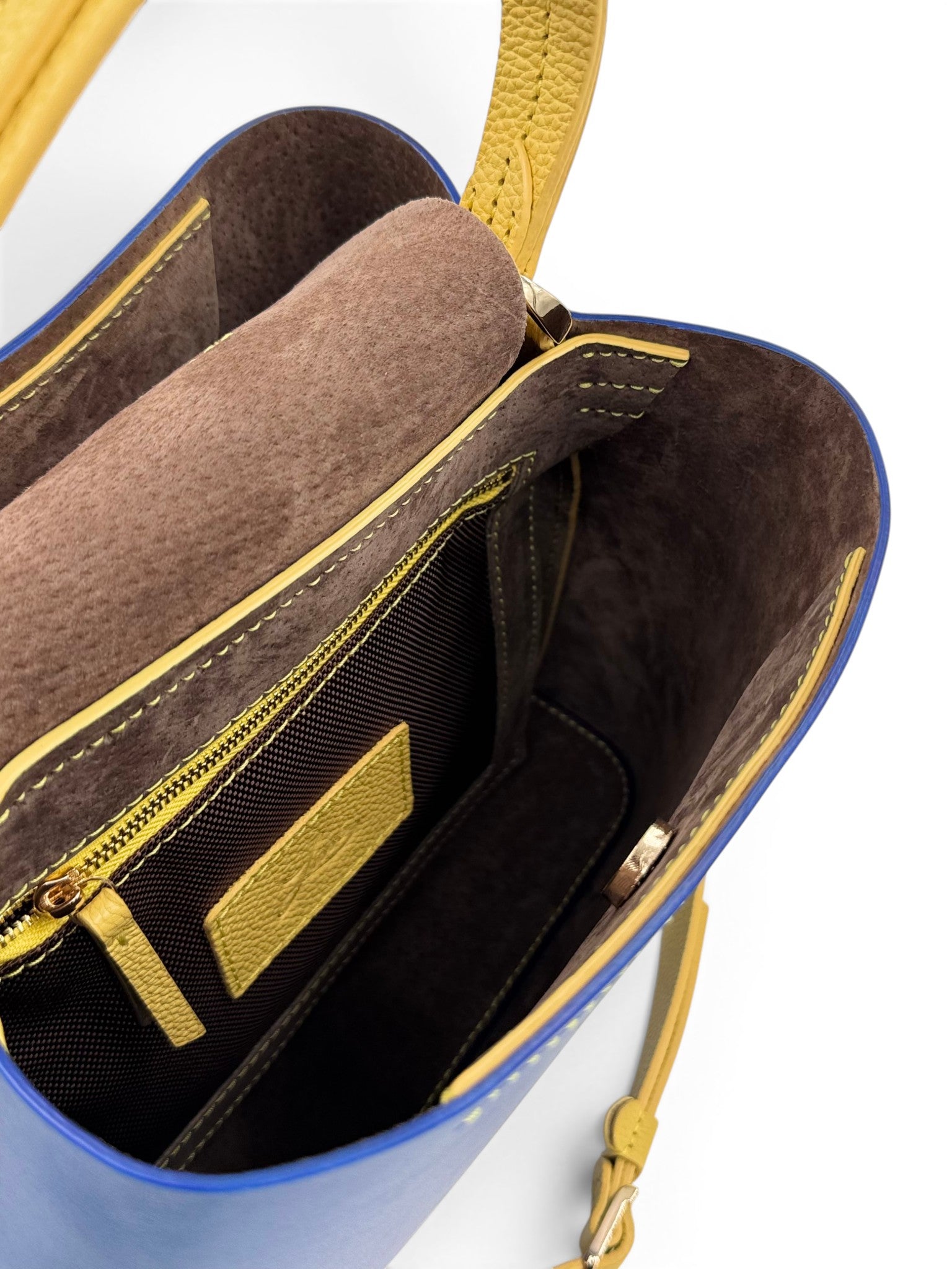 Close-up of a blue and yellow leather bag with gold accents