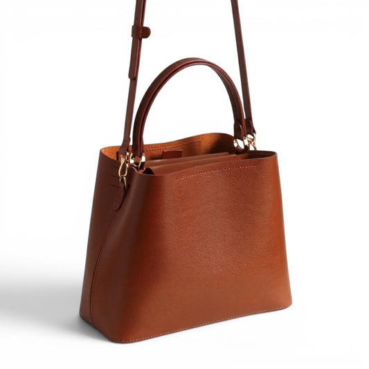 Brown handbag with a handle and a crossbody strap