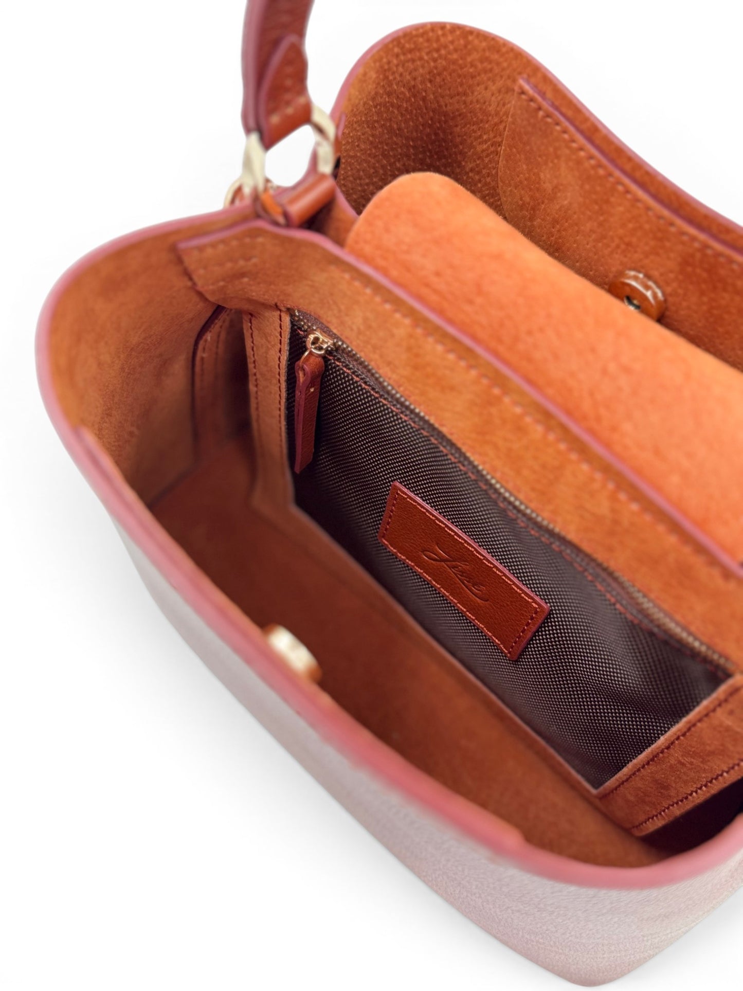 Brown leather handbag with a visible brand label