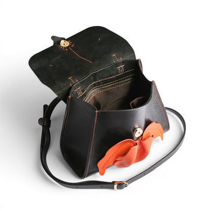 Black leather handbag with orange orchid 