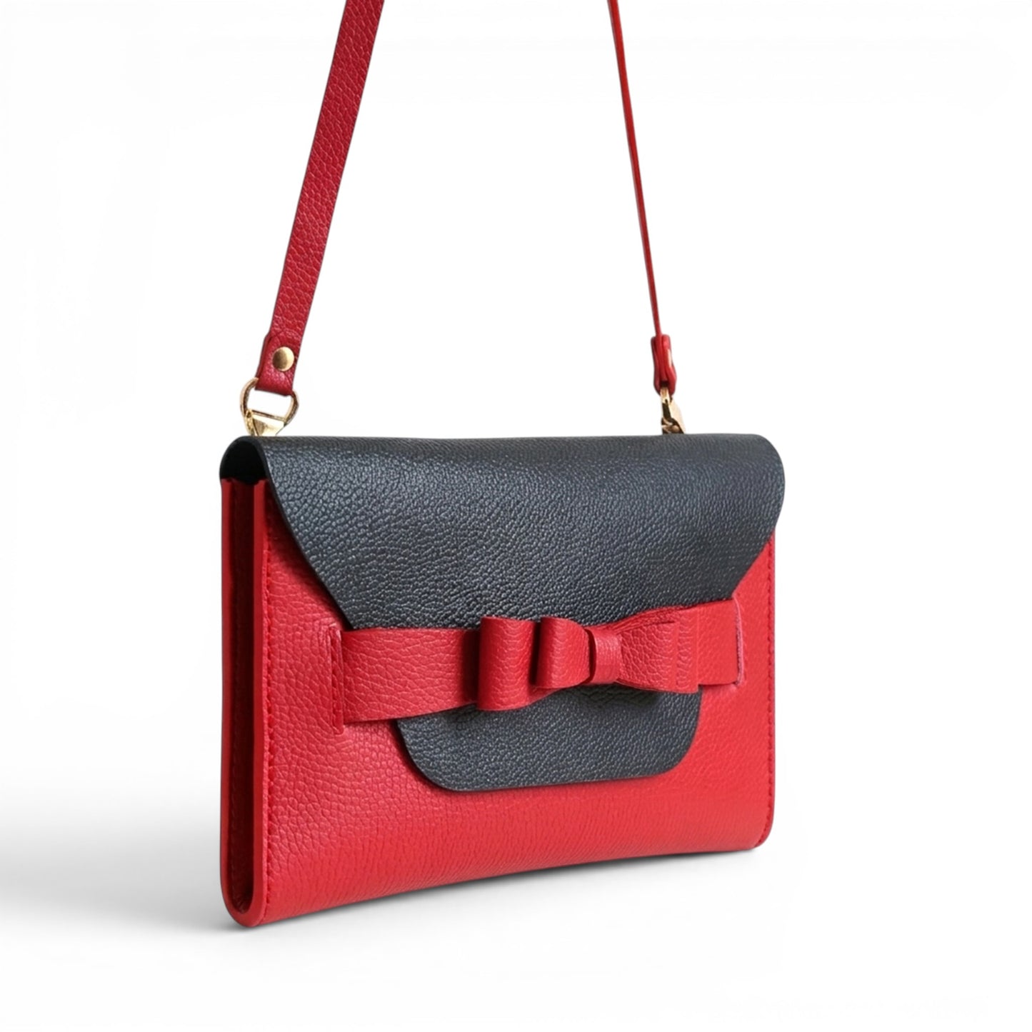 Red and black leather clutch bag with a bow