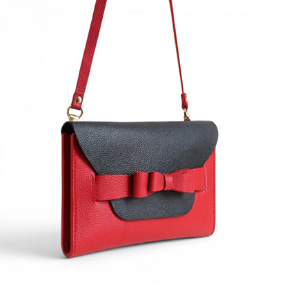 Red and black leather clutch bag with a bow