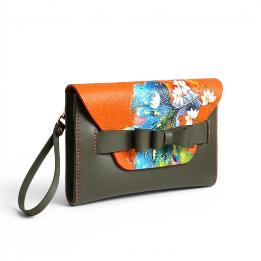 Floral-patterned leather clutch bag with orange and green design