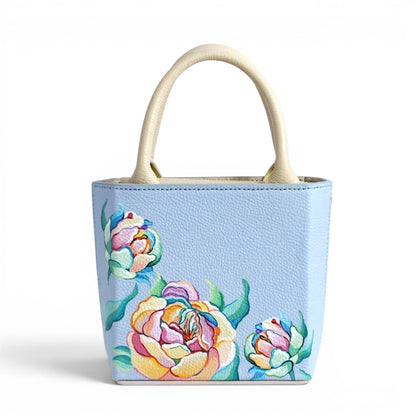 Light blue leather handbag with floral designs