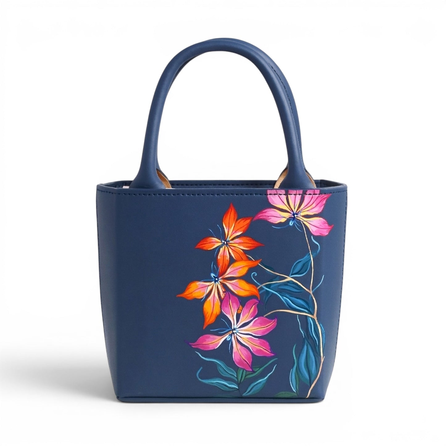 Blue leather handbag with floral designs on a white background