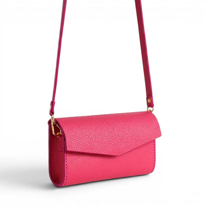 Coral leather clutch bag with crossbody strap