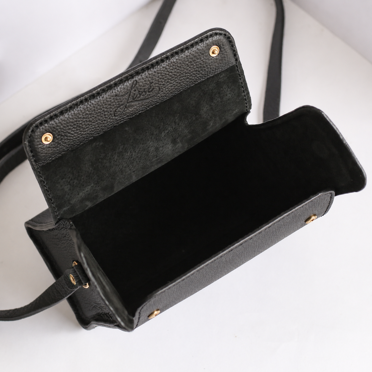 Inside Black leather handbag with gold hardware